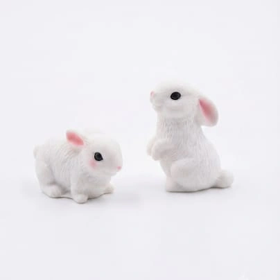 A charming white miniature rabbit figurine set of 2, perfect for enhancing any dollhouse or diorama product scene.