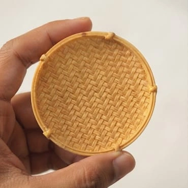 A beautifully crafted miniature wicker round tray, perfect as a decor product for dollhouses and miniature scenes.