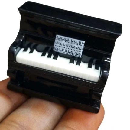 Detailed miniature black grand piano figurine, an elegant product for dollhouse scenes or collector displays.