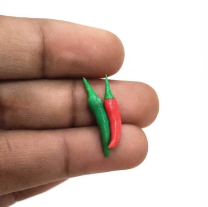 A realistic miniature chili pepper set of 2, a perfect dollhouse food product for tiny kitchen scenes.