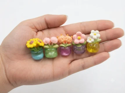 Charming miniature glitter flower pot, randomly selected, adds sparkle to your dollhouse product display.