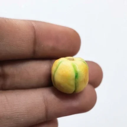 A realistic miniature green apple figurine product, perfect for dollhouse food displays or diorama scenes.