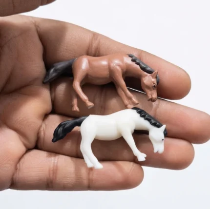 A delightful miniature horse figurine product set of 2, showcasing detailed craftsmanship and realistic poses.