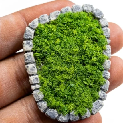 Detailed miniature moss terrarium product with natural stone border, perfect for tiny display or collection.