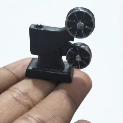 A highly detailed miniature movie projector figurine product, perfect for dollhouse scenes and collector displays.