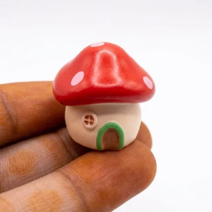 Charming Miniature Mushroom House Figurine product, perfect for fairy gardens or miniature displays.