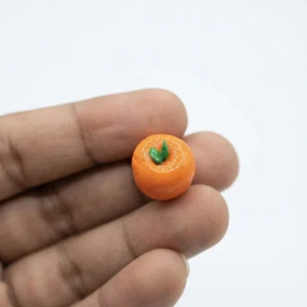 Beautifully detailed miniature orange apricot figurine product, perfect for tiny scenes or collections.