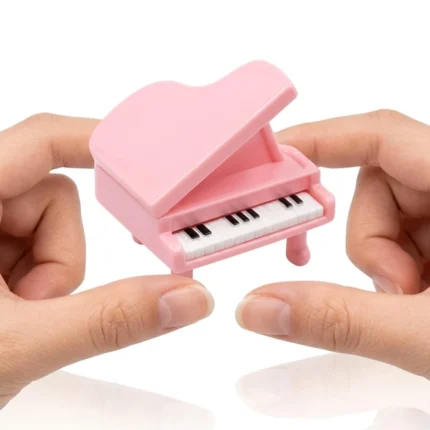 Charming miniature pink grand piano figurine product, ideal for dollhouse scenes or as a collectible display.