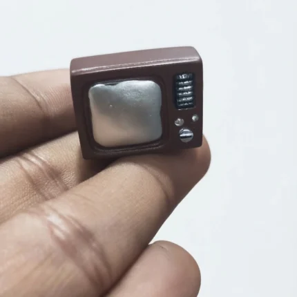 A detailed miniature retro television figurine product, ideal for vintage charm in dollhouse or display.