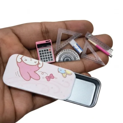A detailed miniature school supplies set product featuring tiny books, pens, and a ruler for dollhouse scenes.