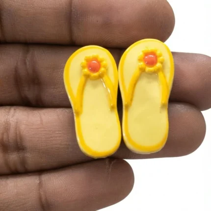 Bright yellow miniature flip flop sandals, perfect for dollhouse beach scenes or tiny product displays.