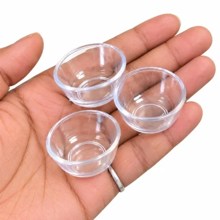 A small, clear plastic miniature bowl with a random design, ideal as a dollhouse kitchen product.