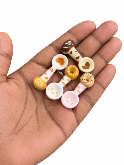 Charming miniature coffee donut spoon product, ideal for dollhouse scenes or craft projects.