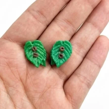 Product image of a miniature green leaf figurine set of 2, ideal for dollhouse or diorama landscaping.