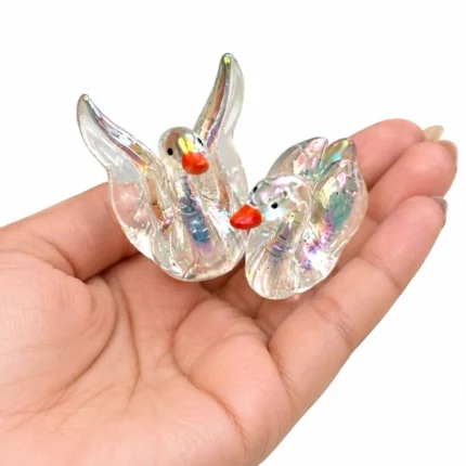 Miniature glowing glass swan, Type 2, with intricate detail and luminous effect, a collectible product.