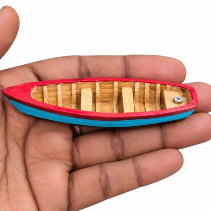 Detailed miniature red and blue rowing boat figurine product for nautical displays or dollhouses.